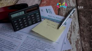 Calculator, pen, and HMRC Self Assessment Form